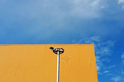 Low angle view of yellow street light against sky