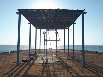Lifeguard hut on beach against clear sky
