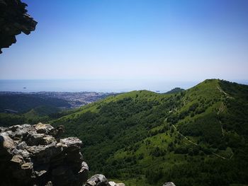 Scenic view of landscape and mountains against clear sky