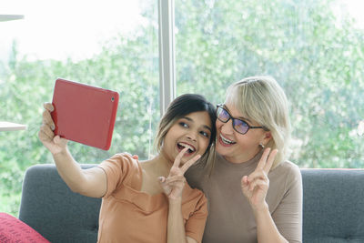 Portrait of smiling young woman using mobile phone