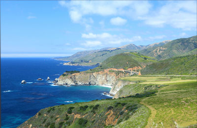 Scenic view of sea and mountains against sky