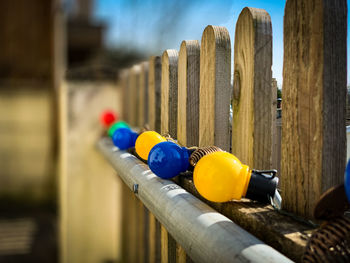 Close-up of multi colored pencils on wooden post