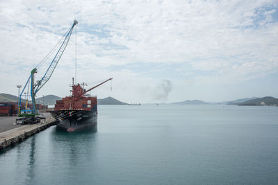 Ship at harbor against sky