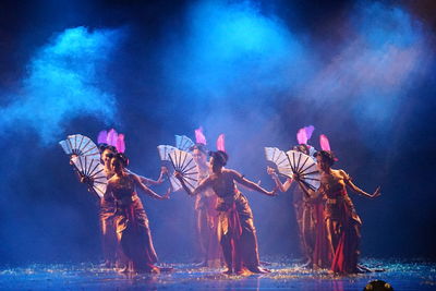 Group of people dancing at night