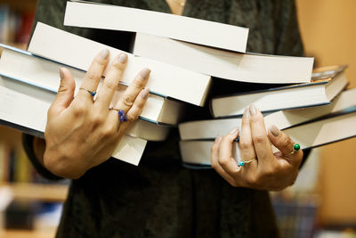 Midsection of woman holding book