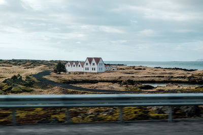 Building by sea against sky