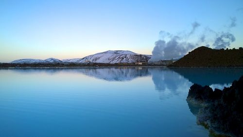 Scenic view of lake and mountains against sky