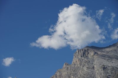 Low angle view of mountain against blue sky