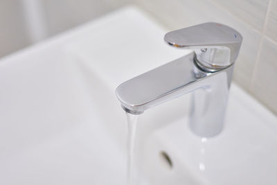 Close-up of faucet in bathroom