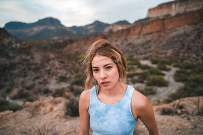 Portrait of woman standing on mountain