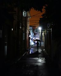 Illuminated walkway at night