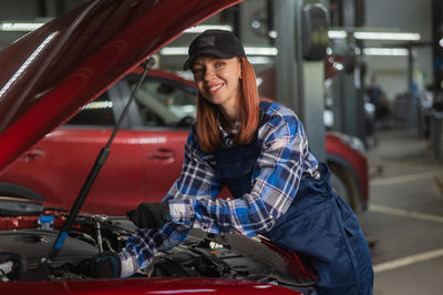 Side view of young woman in car