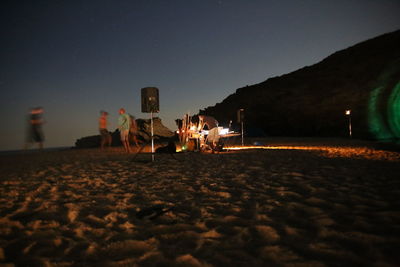 People on sand at night