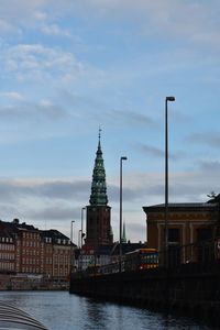 Canal amidst buildings against sky in city