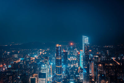 Illuminated cityscape against sky at night