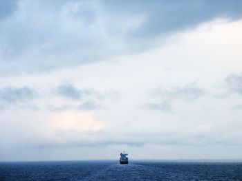 Scenic view of sea against sky with a lonely ship