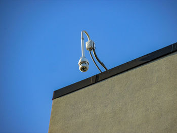 Low angle view of telephone pole against clear sky