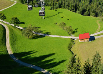 High angle view of road amidst trees on field