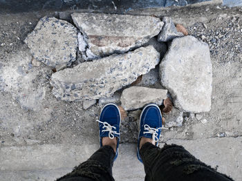 Low section of man standing on rock