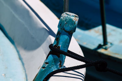 Close-up of rope tied on metal railing