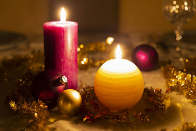 Close-up of illuminated christmas decorations on dining table