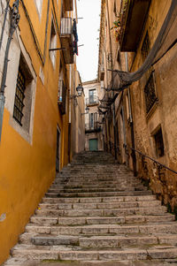 Low angle view of narrow alley amidst buildings