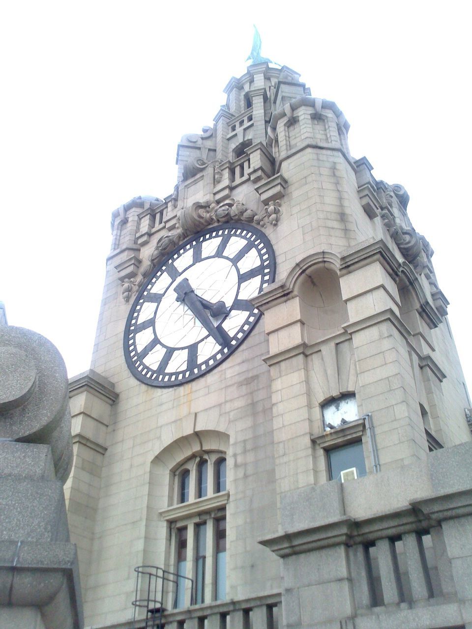 architecture, clock, low angle view, time, building exterior, built structure, clear sky, clock tower, window, old, day, history, tower, sky, clock face, outdoors, no people, city, number, old-fashioned