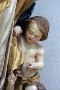 Close-up of angel statue at altar against wall