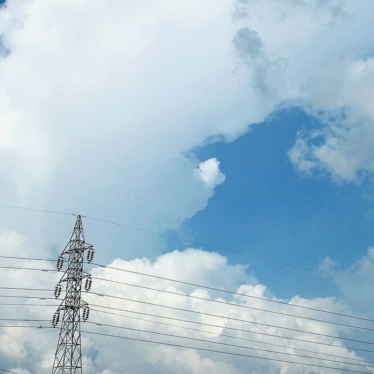 low angle view, sky, cloud - sky, power line, electricity, cloudy, connection, electricity pylon, technology, cable, built structure, fuel and power generation, power supply, cloud, day, high section, no people, architecture, outdoors, weather