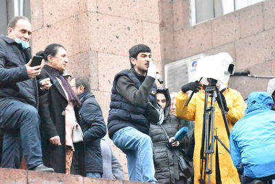 People photographing on street in city