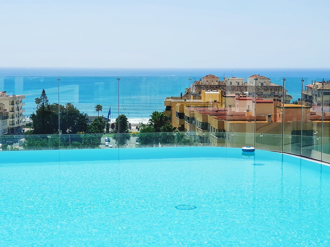 VIEW OF SWIMMING POOL BY SEA AGAINST SKY