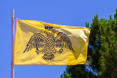 Sparta, greece, july 20, 2022. flag of the greek orthodox church in the city of sparta