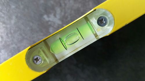 Close-up of yellow telephone on table
