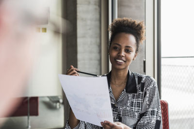 Young woman talking to senior colleague