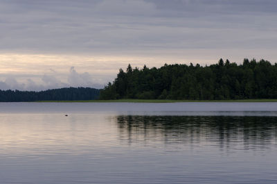 Scenic view of lake against sky at sunset