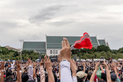 Group of people in park against sky