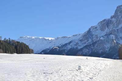 Scenic view of snow mountains against clear blue sky