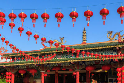 Low angle view of lanterns hanging against sky