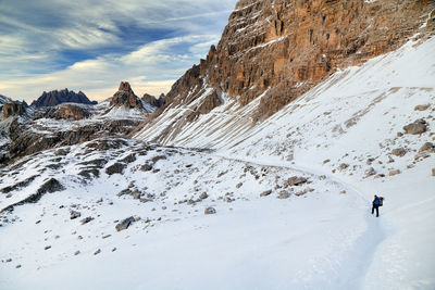 People skiing on snowcapped mountain against sky