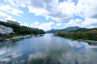 Arch bridge over river against sky