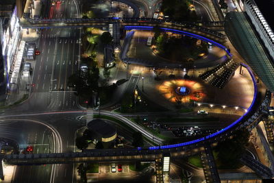 High angle view of illuminated bridge and buildings at night