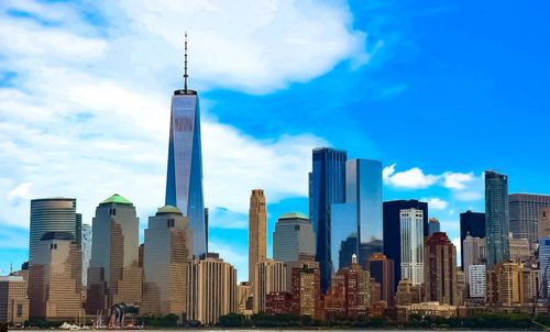 Skyscrapers in city against blue sky