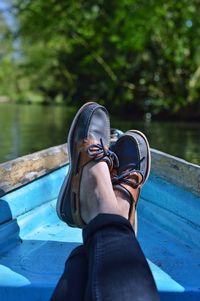 Low section of man on boat in lake