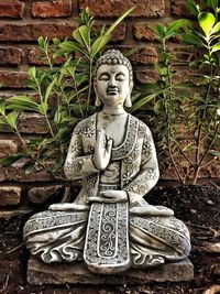 Statue of buddha against temple