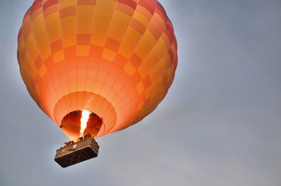 Low angle view of hot air balloon flying against sky