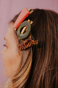 Close-up portrait of a young woman showing hair clips