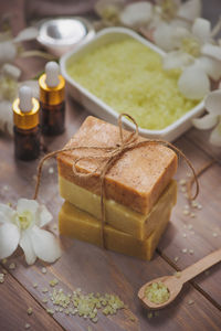 Spa setting with orchid, spoon,towel, soap, salt stones on old wooden background