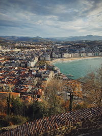 High angle view of townscape by river against sky