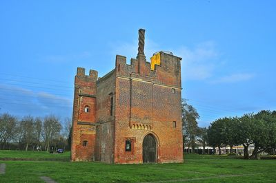 Old building on field against sky