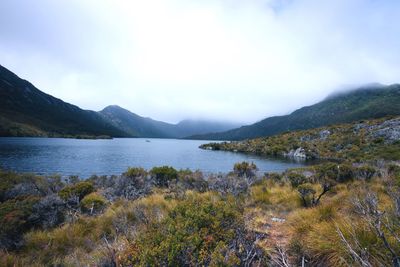 Scenic view of lake and mountains against sky